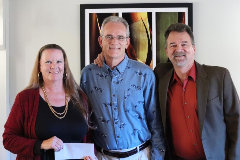 Hickory Nut Gorge Outreach President &amp; Office Manager Karen King accepts a $5000 donation from Jeff Geisler, RBLL and Chris Dolman, Lake Lure Music Festival 